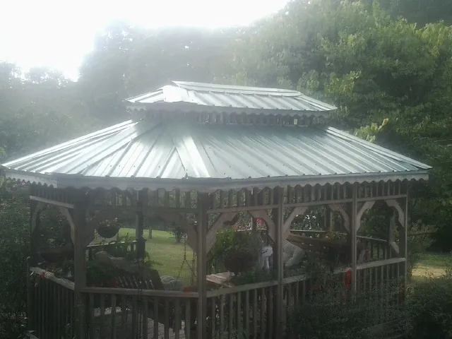 Two tier green metal roof on a garden gazebo in Medford